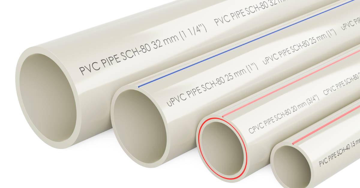 Four white pipes of different sizes next to each other. One pipe has blue markings on it and two others have red marks.